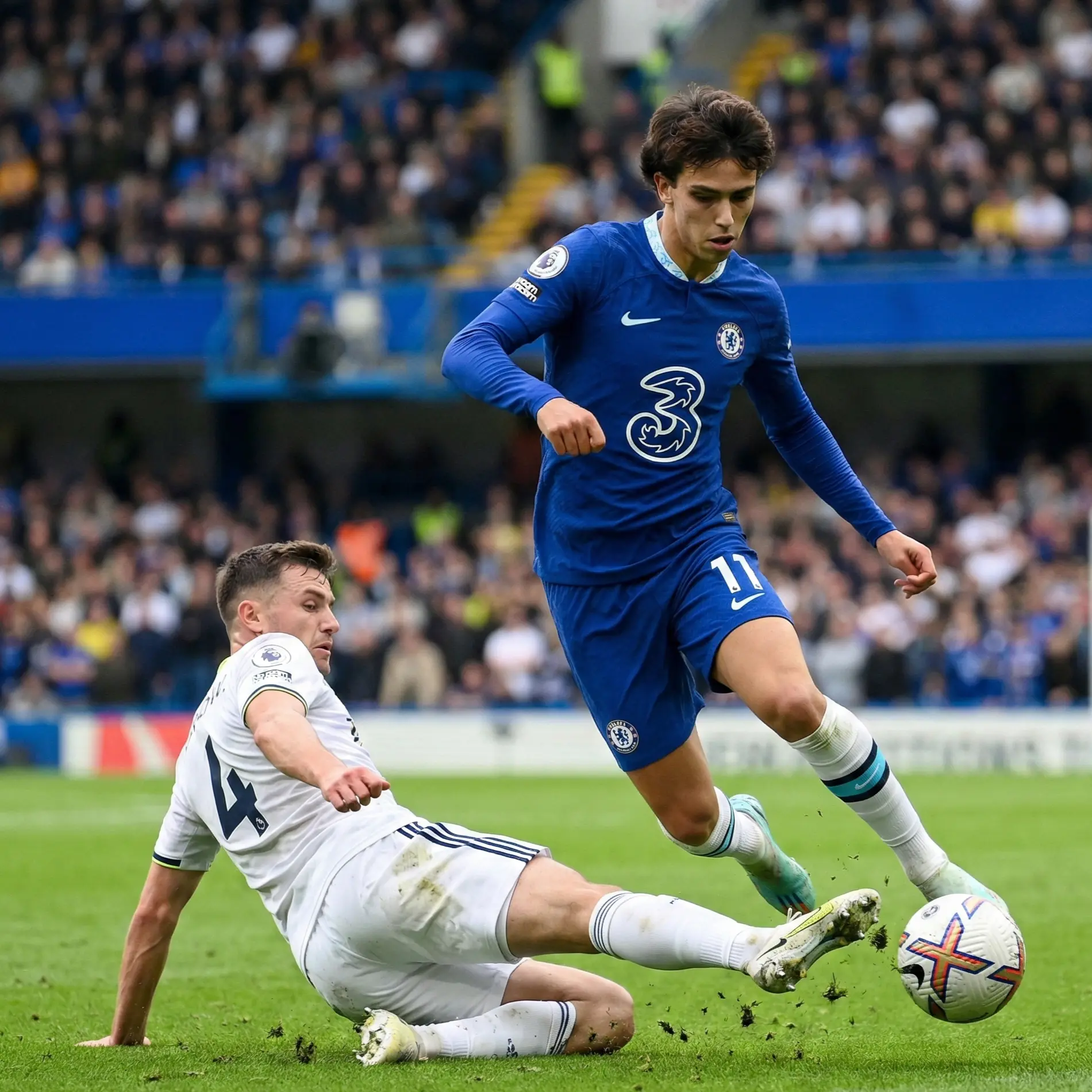 Skilful winger dribbling past defender on football pitch
