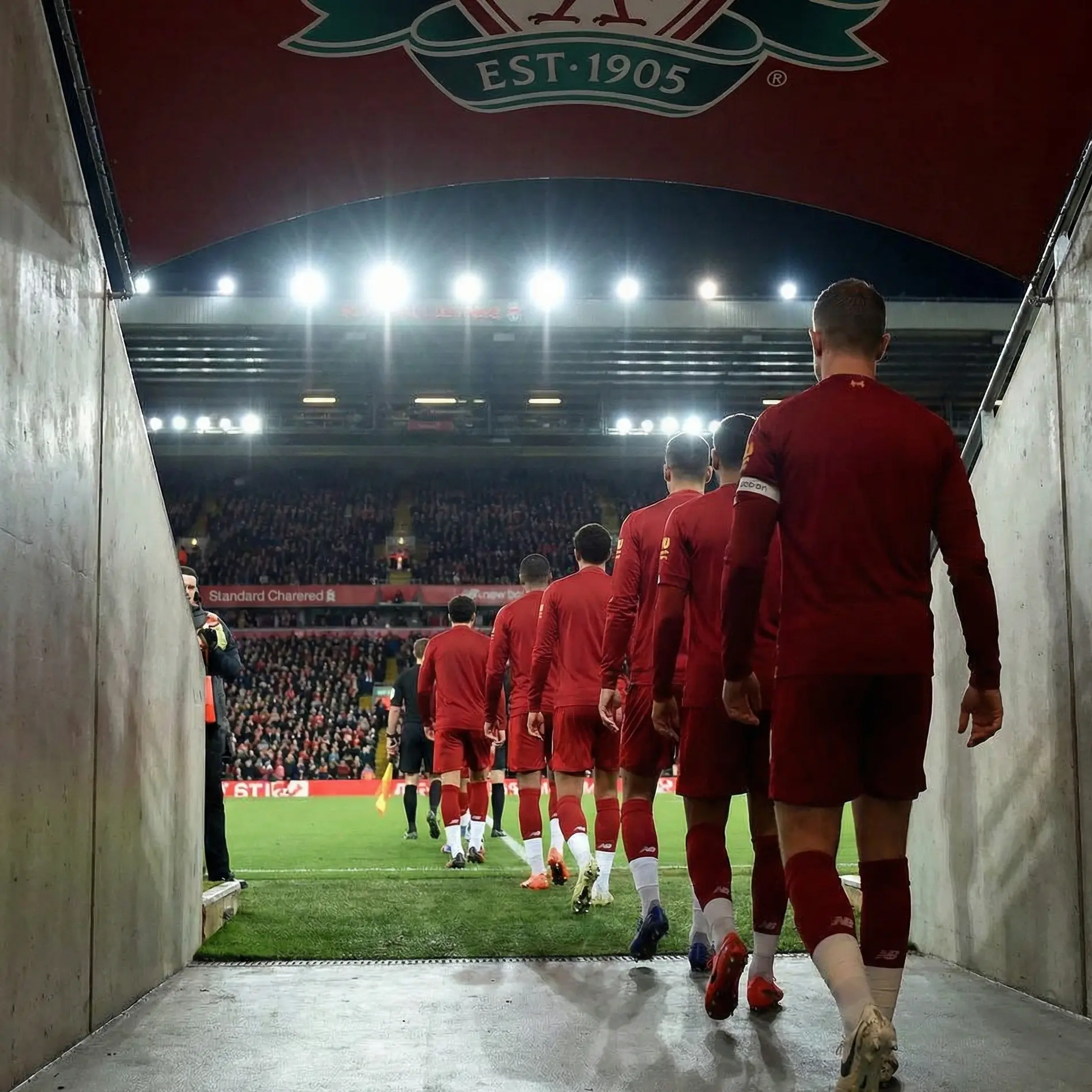 Football team walking onto pitch in formation before match