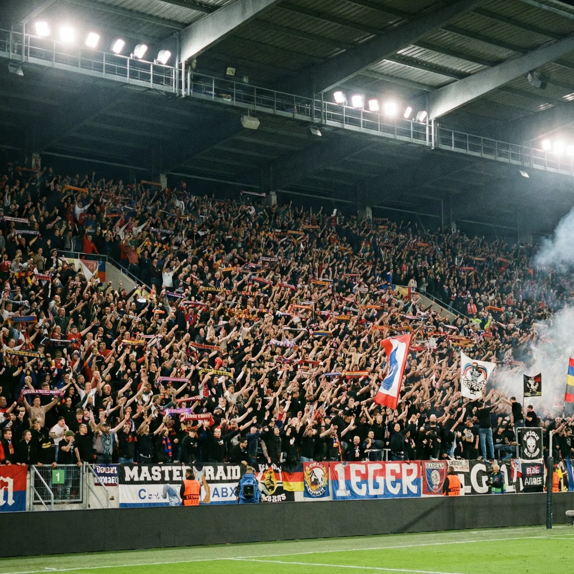 Football stadium crowd creating intense atmosphere during match